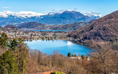 Landscape of lake Ceresio and lake Lugano with Swiss Alps covered with snow. 