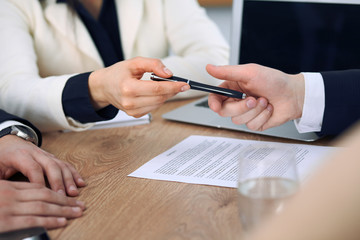 Business woman giving pen to businessman ready to sign contract. Success communication at meeting or negotiation