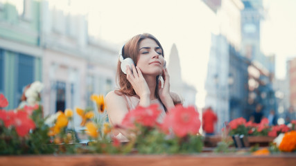 Young girl listen to music on headphones