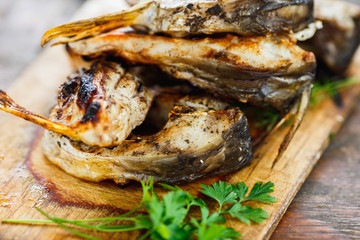 yammy grilled fish pieces with parsley on the board