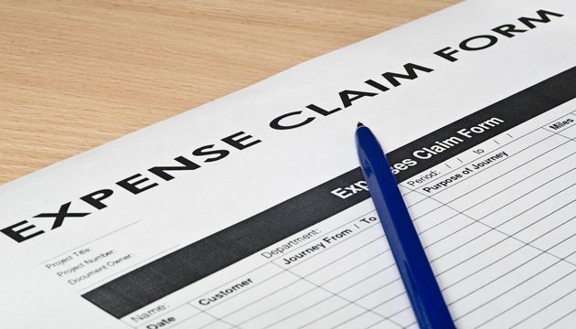 expence claim form on a wooden surface