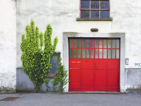 Red Iron Doorway In Old Industrial Building In Italy