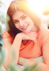 portrait of young smiling woman in the background of the living room.