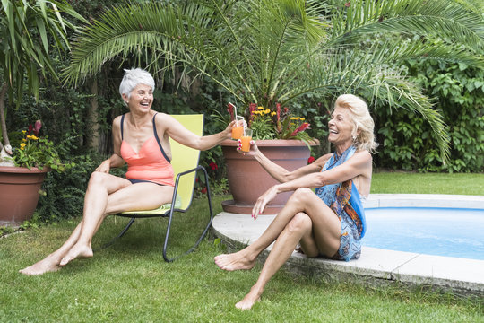Happy and active senior women toasting in the garden