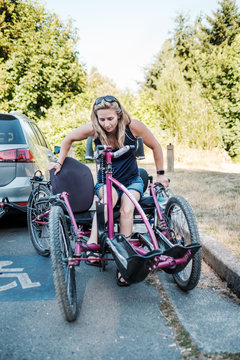 Disabled Active Woman Moving From Wheelchair to Bicycle