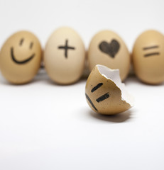 Story of broken heart written by the shells of eggs on the white background