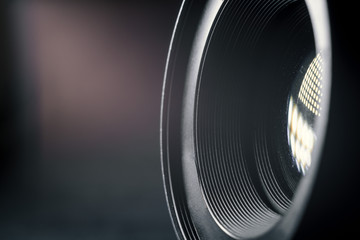 Photo Camera or Video lens close-up on black background, objective, concept of photographer camera man job, looking for a photographer, journalist, a videographer to work