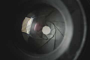 Photo Camera or Video lens close-up on black background, objective, concept of photographer camera man job, looking for a photographer, journalist, a videographer to work