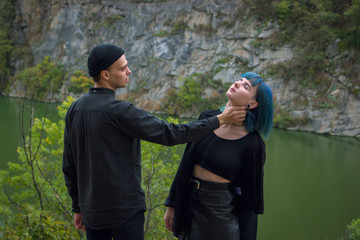 angry boyfriend tries to choke a young woman