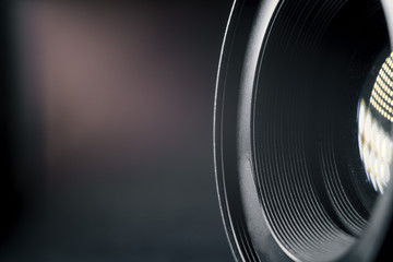 Photo Camera or Video lens close-up on black background, objective, concept of photographer camera man job, looking for a photographer, journalist, a videographer to work