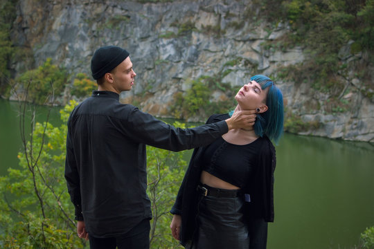 angry boyfriend tries to choke a young woman