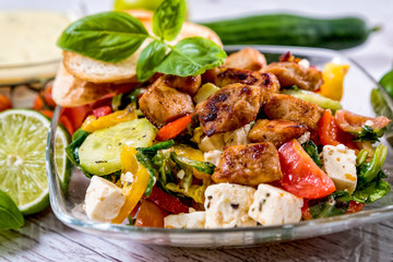 salad, Greek, Italian, tomato mozzarella Basil leaves, peppercorn and olive oil on a wooden table. Recipe - Composition