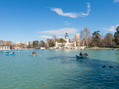 People enjoying a boat ride on the pond in El Retiro Park in Madrid, Spain.
