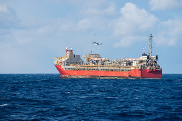 Helicopter is landing on offshore oil installation