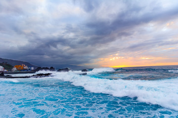 Tenerife, Canary islands, Spain: Sun setting on the Atlantic Ocean on a stormy weather