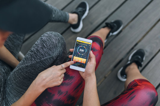 Young women using a running App in smartphone