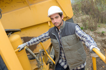 posing on a heavy equipment