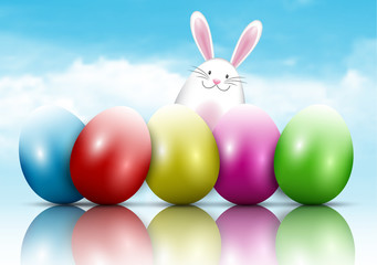 Obraz na płótnie Canvas Easter bunny and eggs on a blue sky background