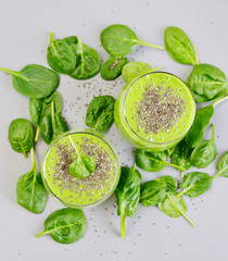 Obraz premium Green spinach smoothies with chia seeds, healthy food concept, detox
