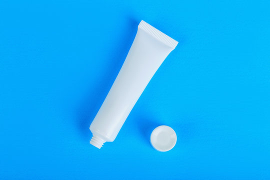 opened white cream tube with copy space