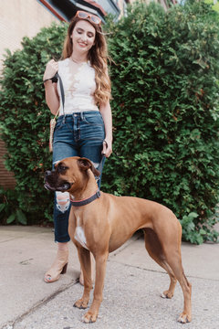 A young woman walking her dog