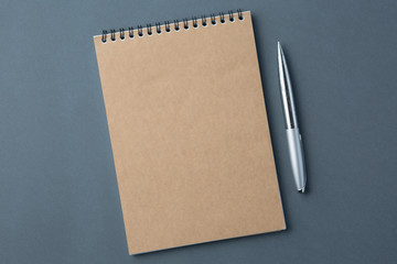 Kraft notebook with pen on black background, craft note pad