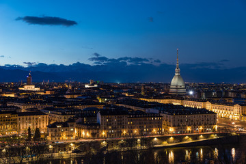Fototapeta na wymiar Turin skyline at dusk, Torino, Italy, panorama cityscape with the Mole Antonelliana over the city. Scenic colorful light and dramatic sky.