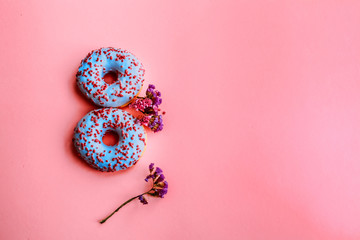 Number eight made of two donuts with flowers on pink background