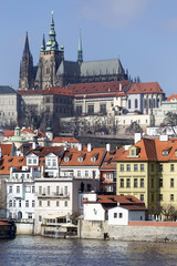 Obraz premium Early Spring Prague gothic Castle with the Lesser Town above River Vltava in the sunny Day, Czech Republic