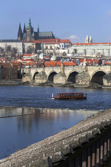 Early Spring Prague gothic Castle and Charles Bridge with the Lesser Town in the sunny Day, Czech Republic