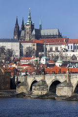 Obraz premium Early Spring Prague gothic Castle and Charles Bridge with the Lesser Town in the sunny Day, Czech Republic