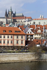 Obraz premium Early Spring Prague gothic Castle with the Lesser Town above River Vltava in the sunny Day, Czech Republic
