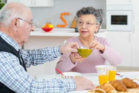 positive loving aged coupel having breakfast