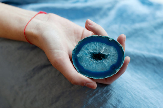 Woman holding blue gemstone