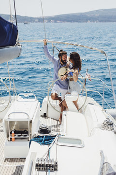 Couple Enjoying Summertime on Sailboat