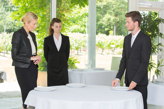 waitress and waiter at catering service in restaurant