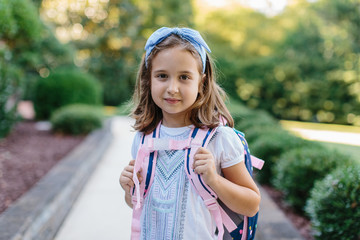 Portrait of a girl with a schoolbag ready for school