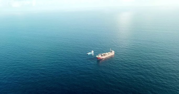 Aerial view of offshore oil installation and supply ship