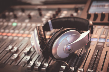 Fototapeta na wymiar Digital music controller and audio mixer for dj party with modern headphones