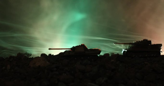 Slider shot. War Concept. Armed forces fighting scene on war fog sky background, World War tanks riding Silhouettes Below Cloudy war Skyline At night. Attack scene. Armored vehicles. Tanks battle. Dec