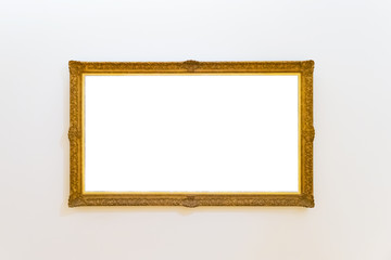 White clipped painting with a wooden carved frame hung on a clear wall.