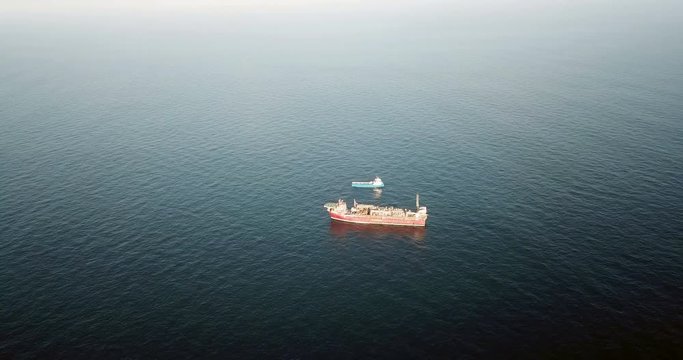 Aerial view of an offshore oil installation and supply ship