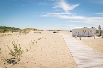 White wooden dressing room at the disposal of swimmers on the beach.