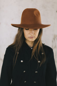 young woman wearing hat