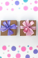 Two Gift boxes on festive background of pastel confetti.