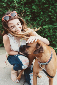 A young woman walking her dog
