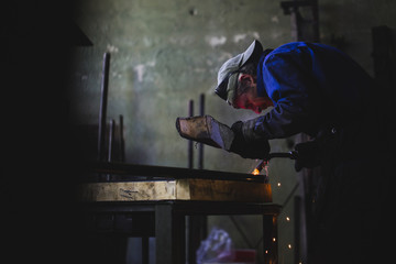 Craftsman welding in his workshop