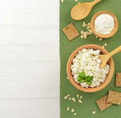 Cottage cheese with sour cream in a wooden bowl