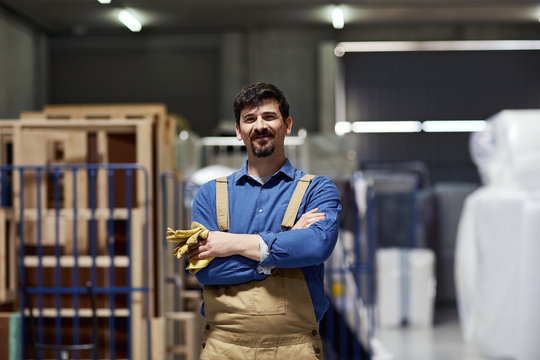 Confident Worker Smiling While Standing Arms Crossed