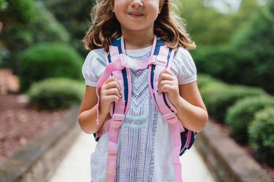 Mid section of a girl with a schoolbag ready for school